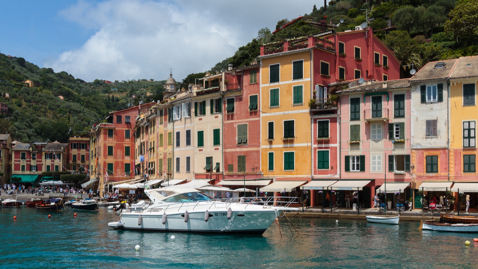 Colored houses in Portofino port with boats in the water