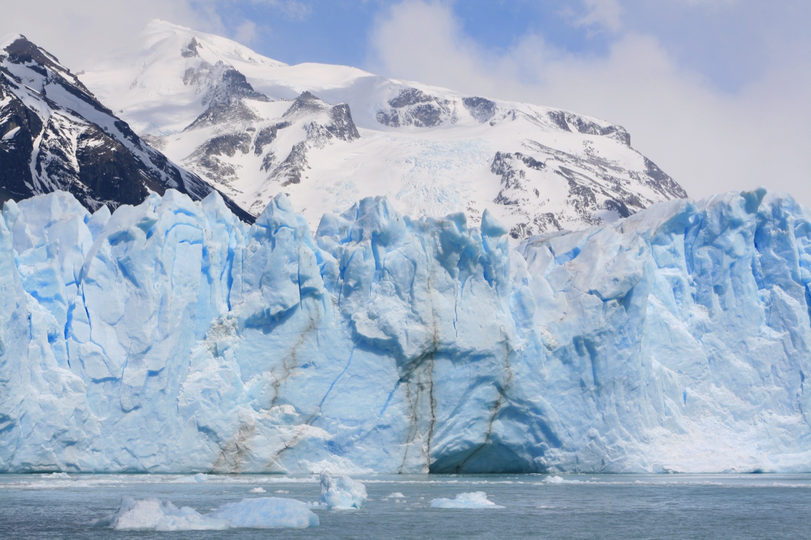Perito Moreno's Blue Glacier Wall with snowy mountains in the background